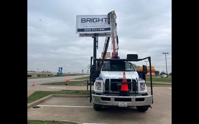 Bucket truck used for licensed commercial sign installation in DFW
